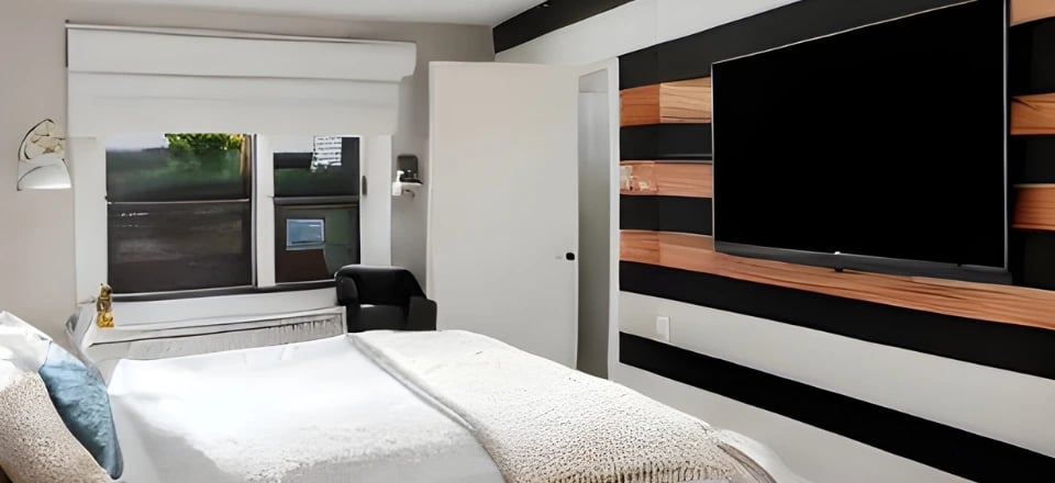 bedroom with a TV and ceiling speakers